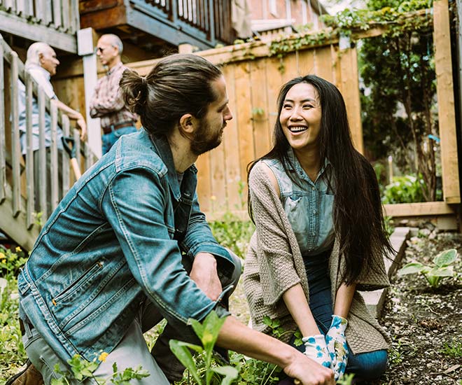 Two neighbors working in a garden